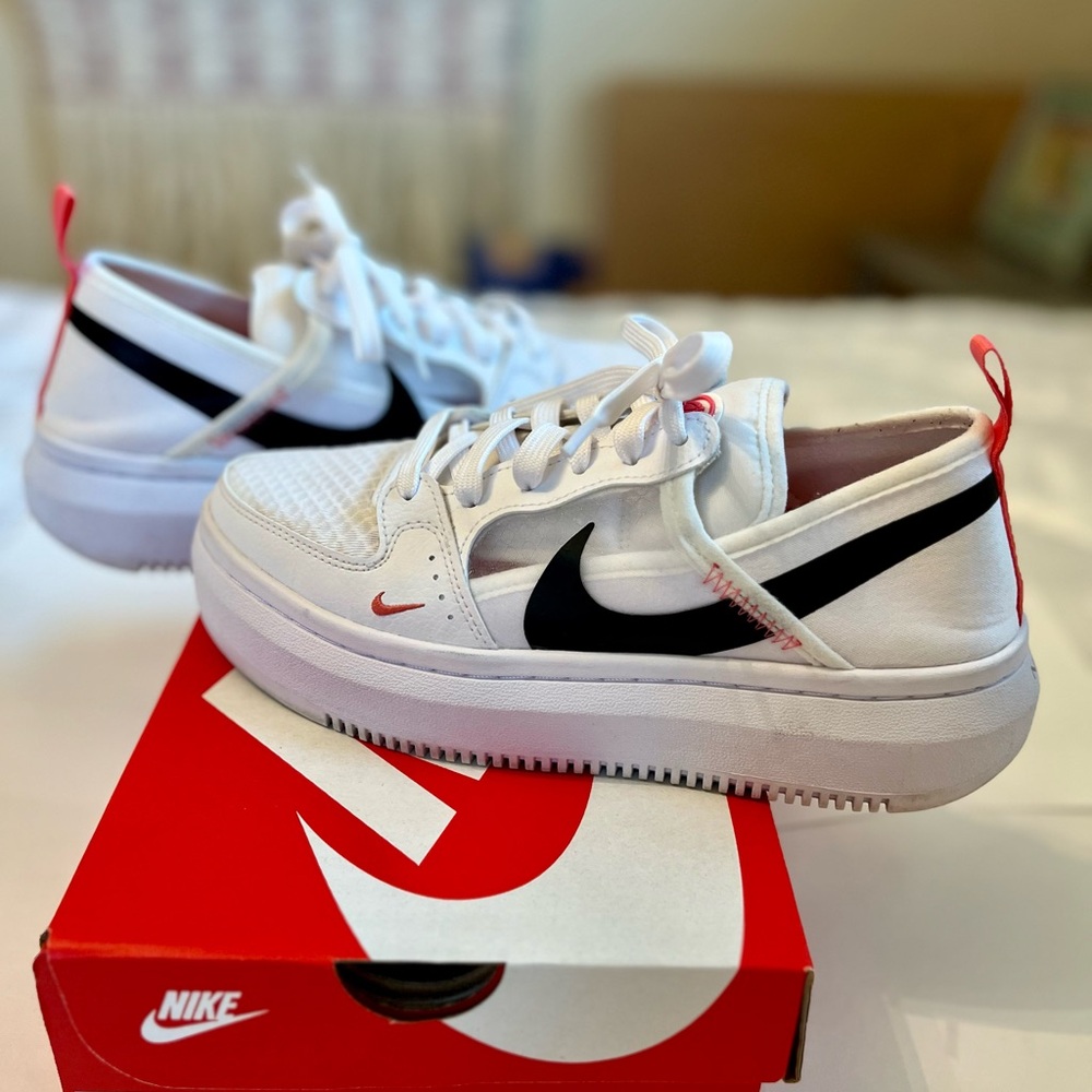 - Nike Women’s White and Black Sneakers